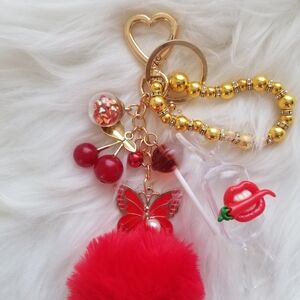 Chic Red Pom Pom Keychain with Gold Accents